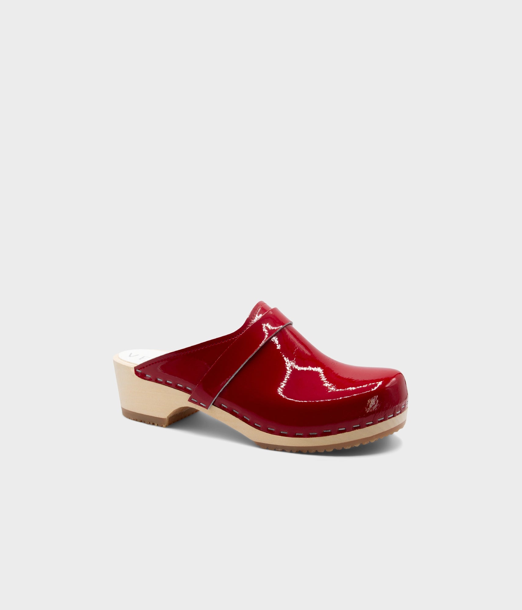 Red clog shoe on a light gray background