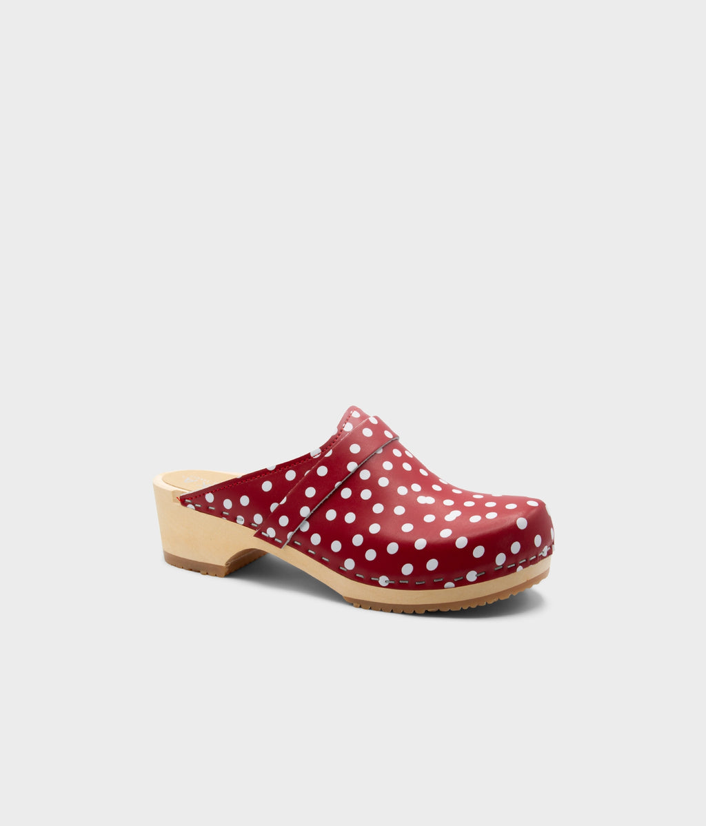 Red polka dot clog mule on a light gray background