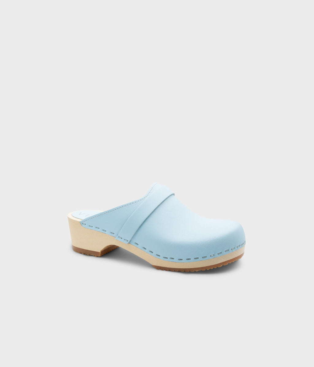Light blue clog shoe on a light gray background