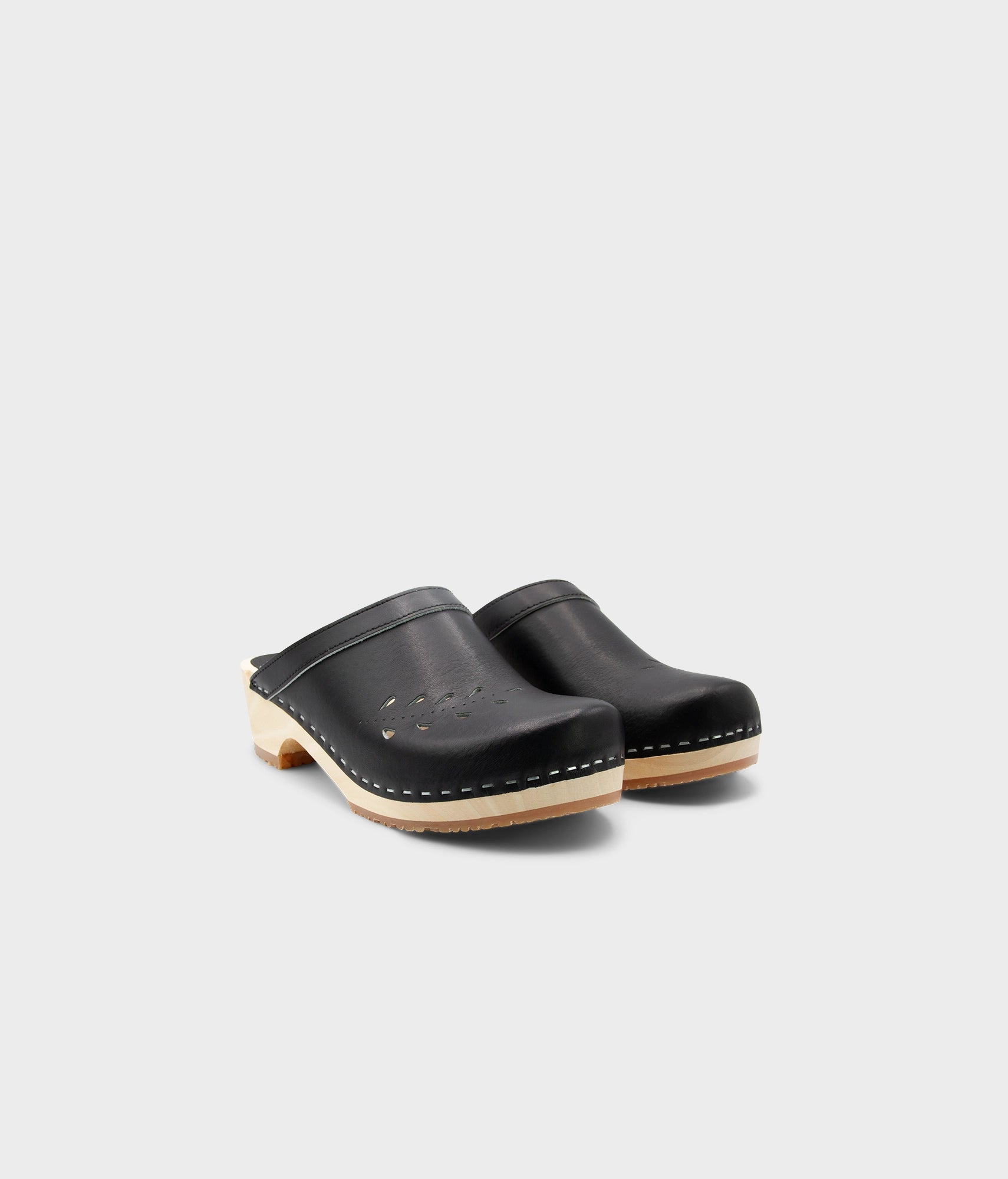 Pair of black clogs on a light gray background
