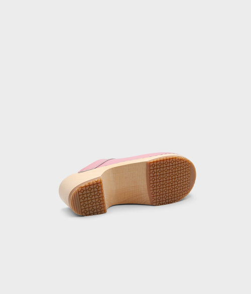 Pink shoe sole with a wooden sole on a light gray background