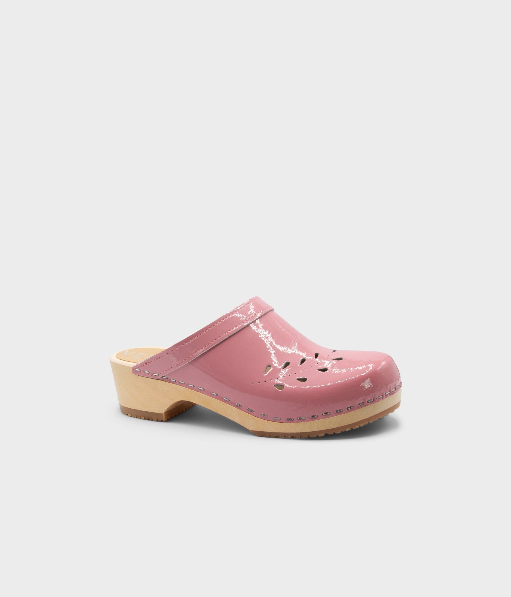 Pink clog shoe on a light gray background