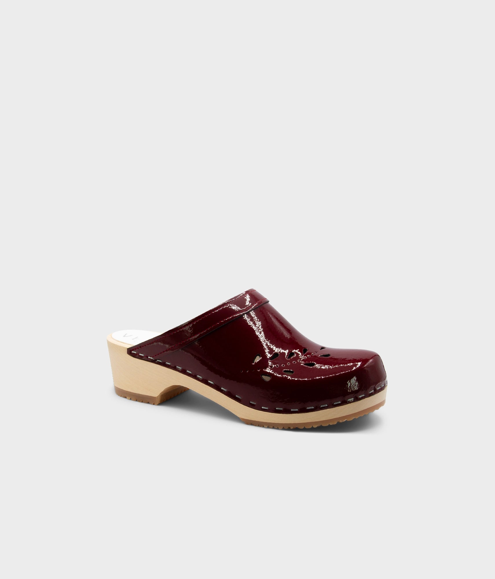 Single maroon clog shoe on a light gray background