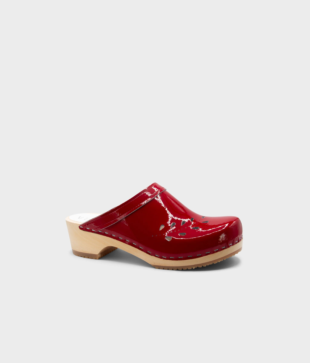 Red clog shoe on a light gray background