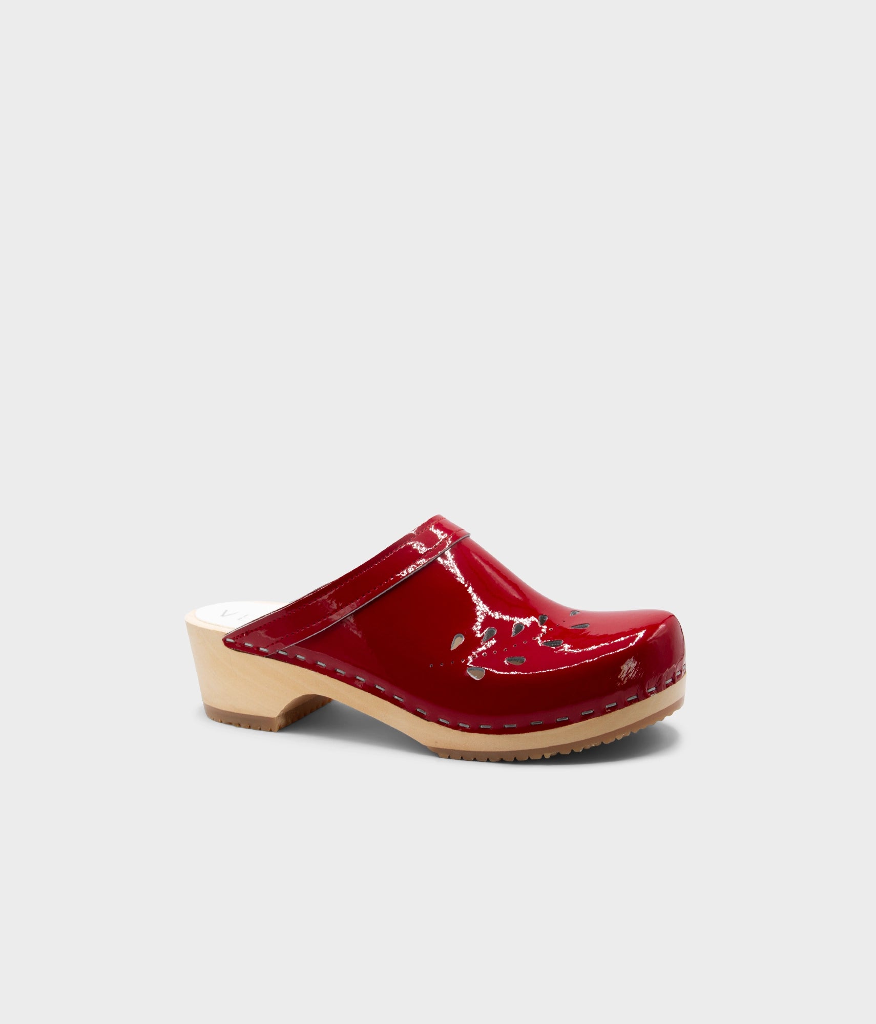 Red clog shoe on a light gray background