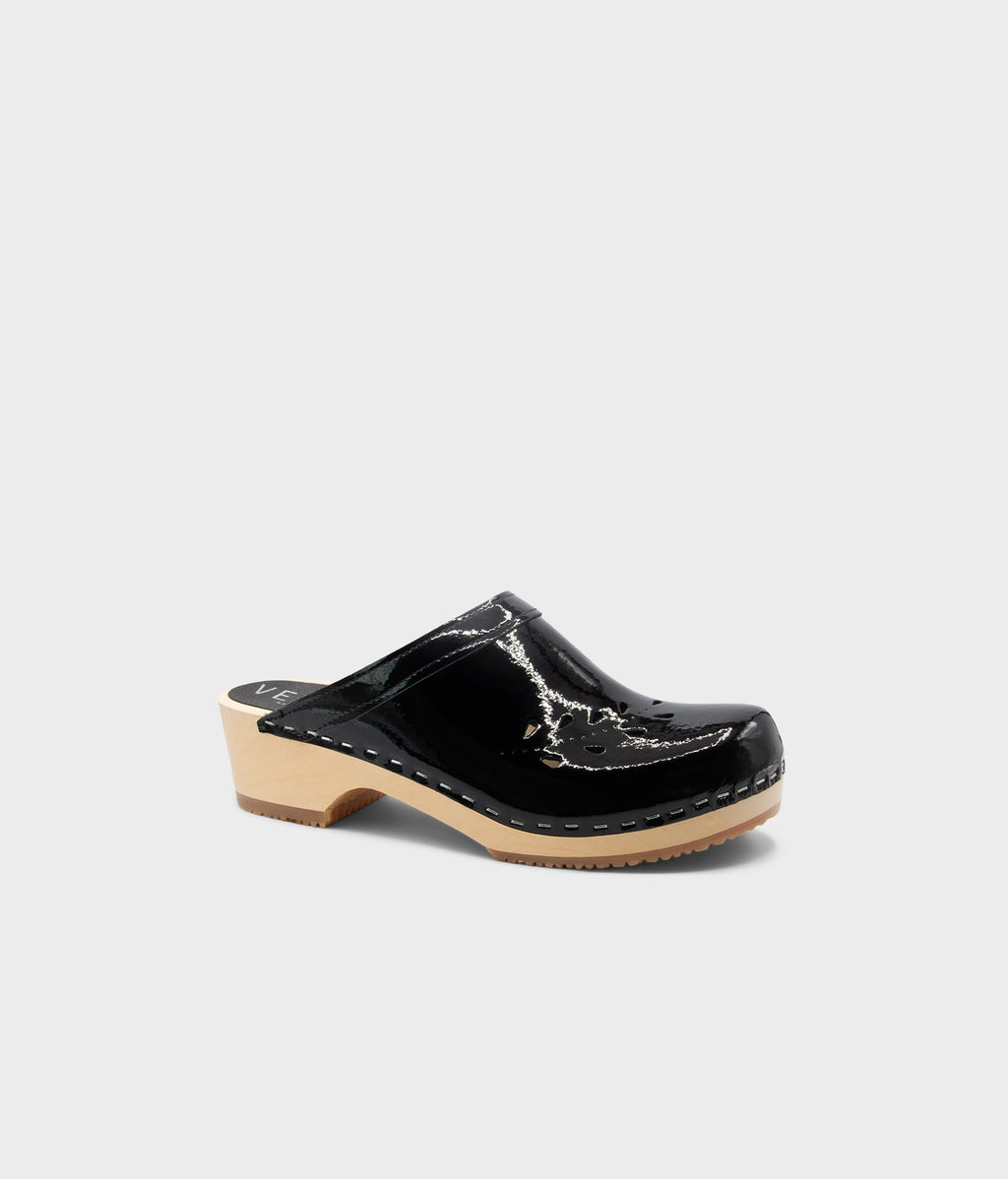 Black clog shoe on a light gray background