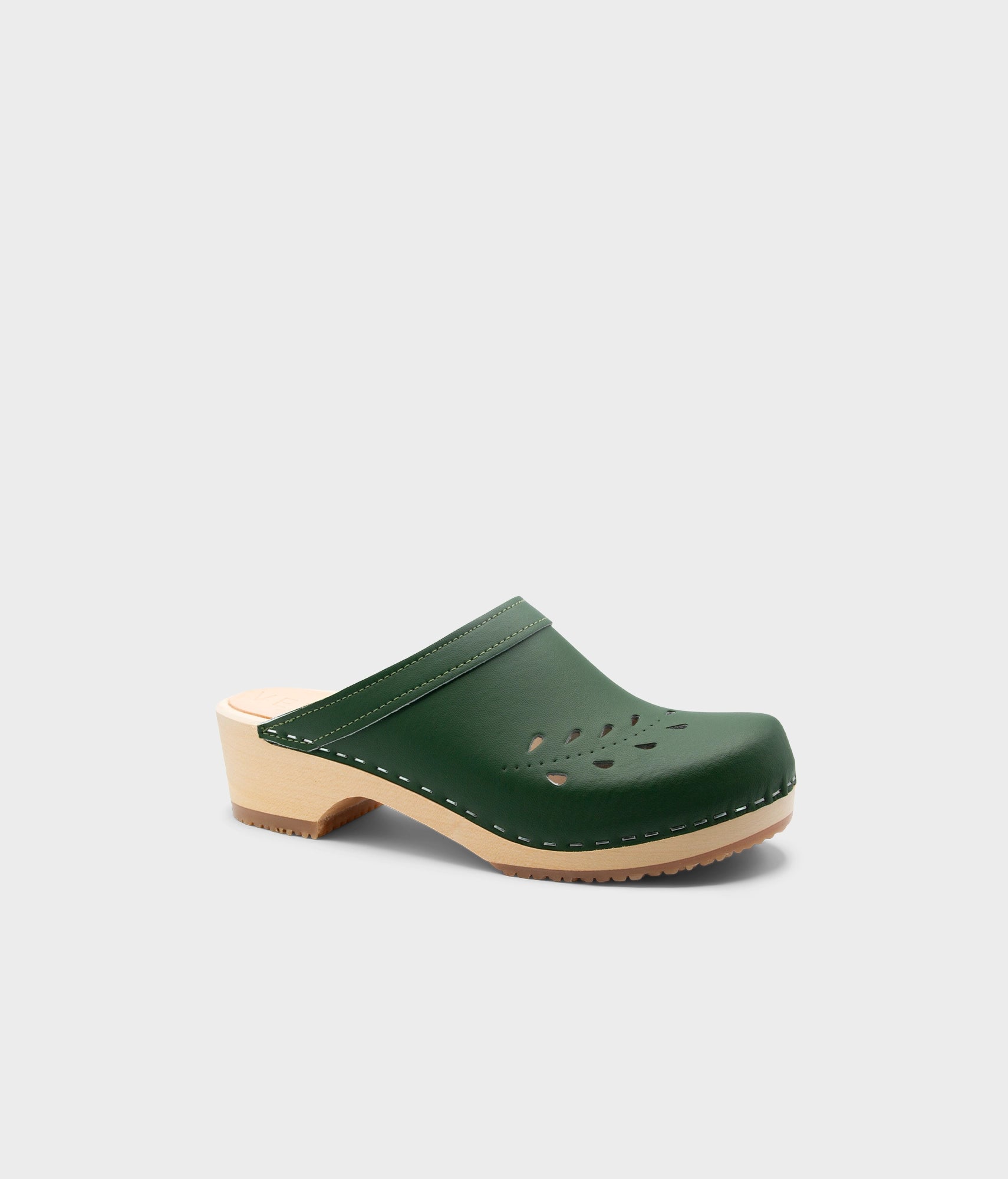 Green clog shoe on a light gray background