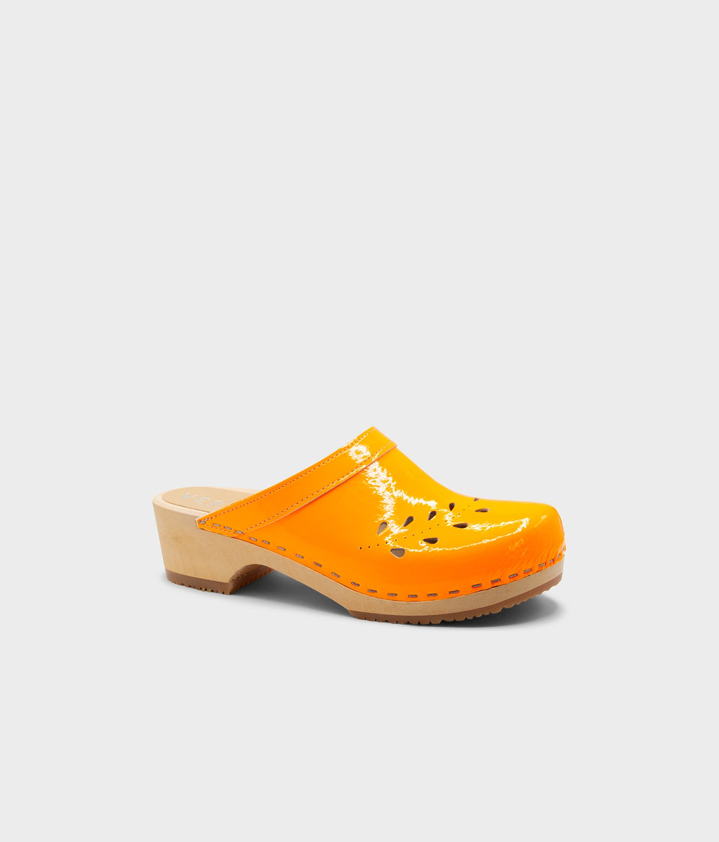 Orange clog shoe on a light gray background