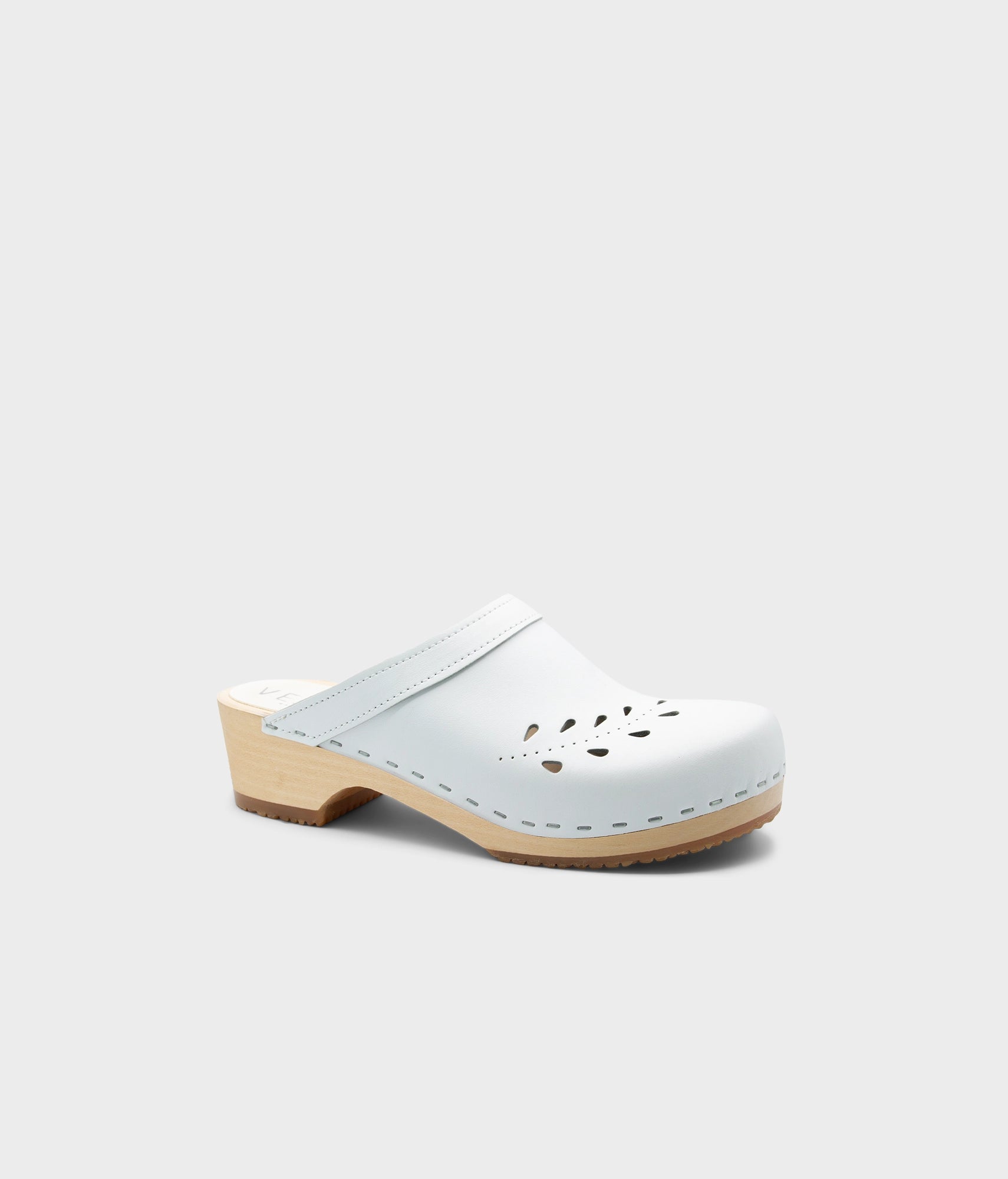 snow wooden clog shoe on a light gray background