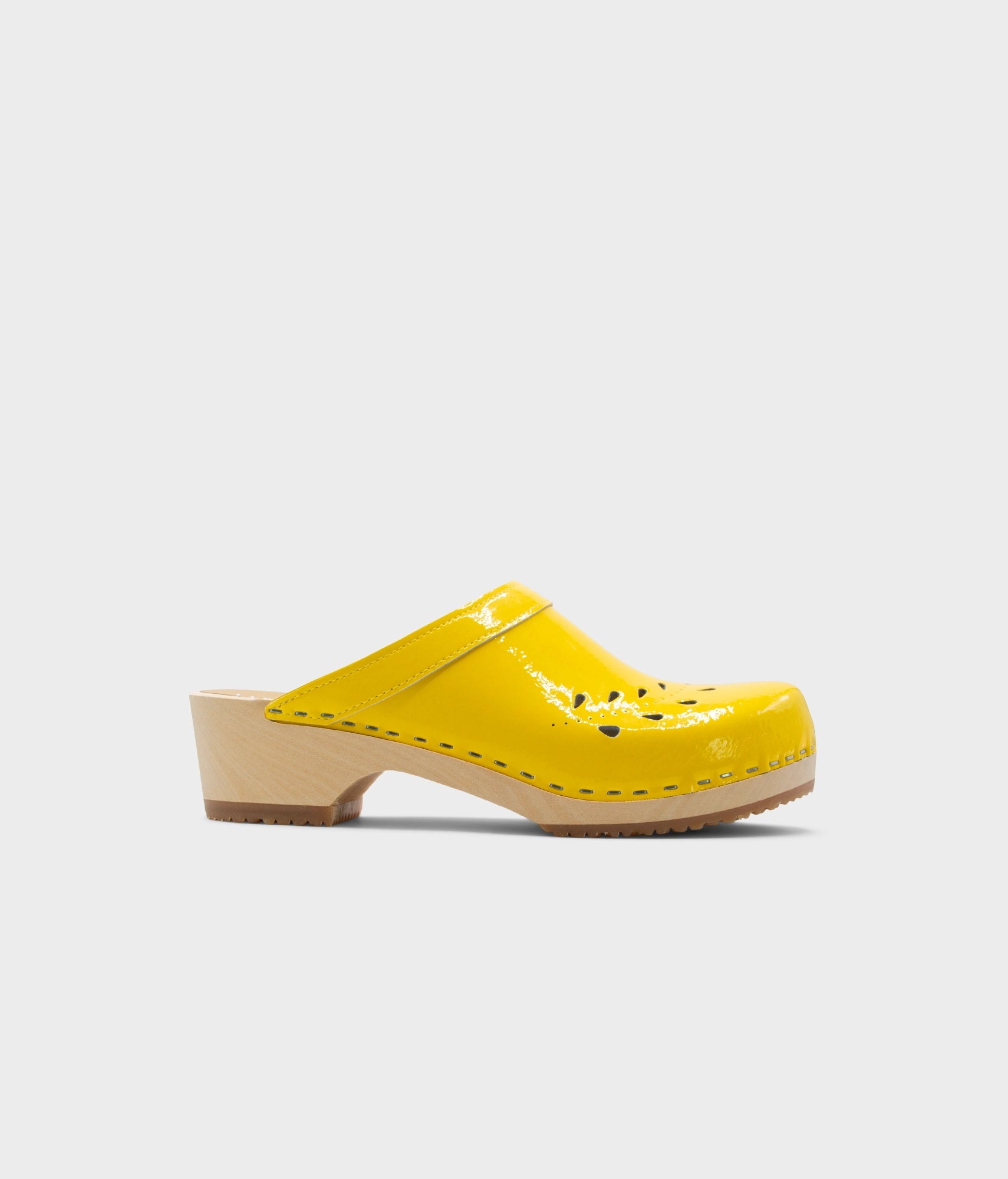 Yellow clog shoe on a light gray background