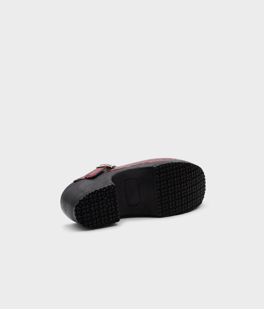 Black rubber sole of a shoe on a light gray background