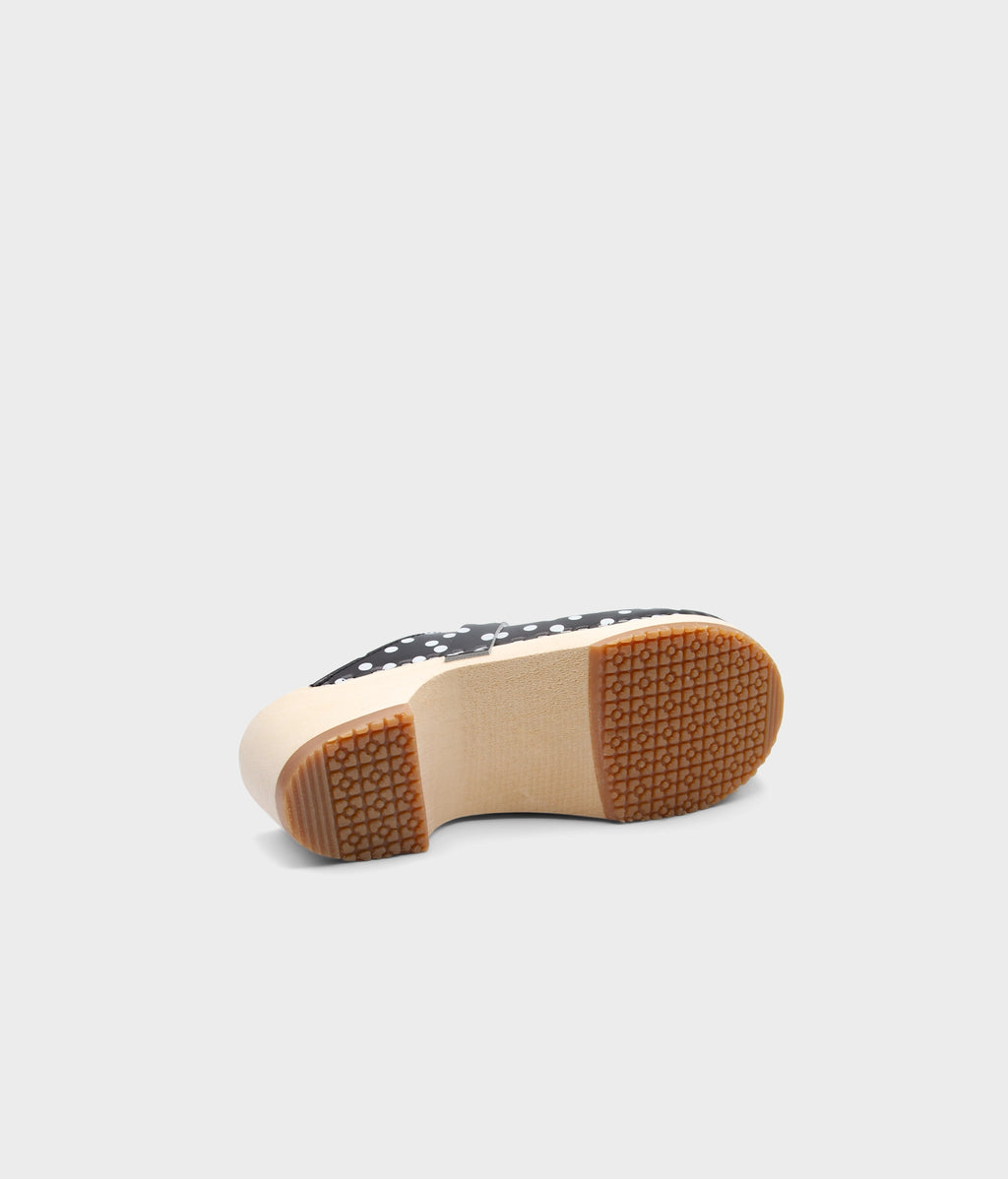 Close-up of a clog mule sole with a patterned design on a light gray background