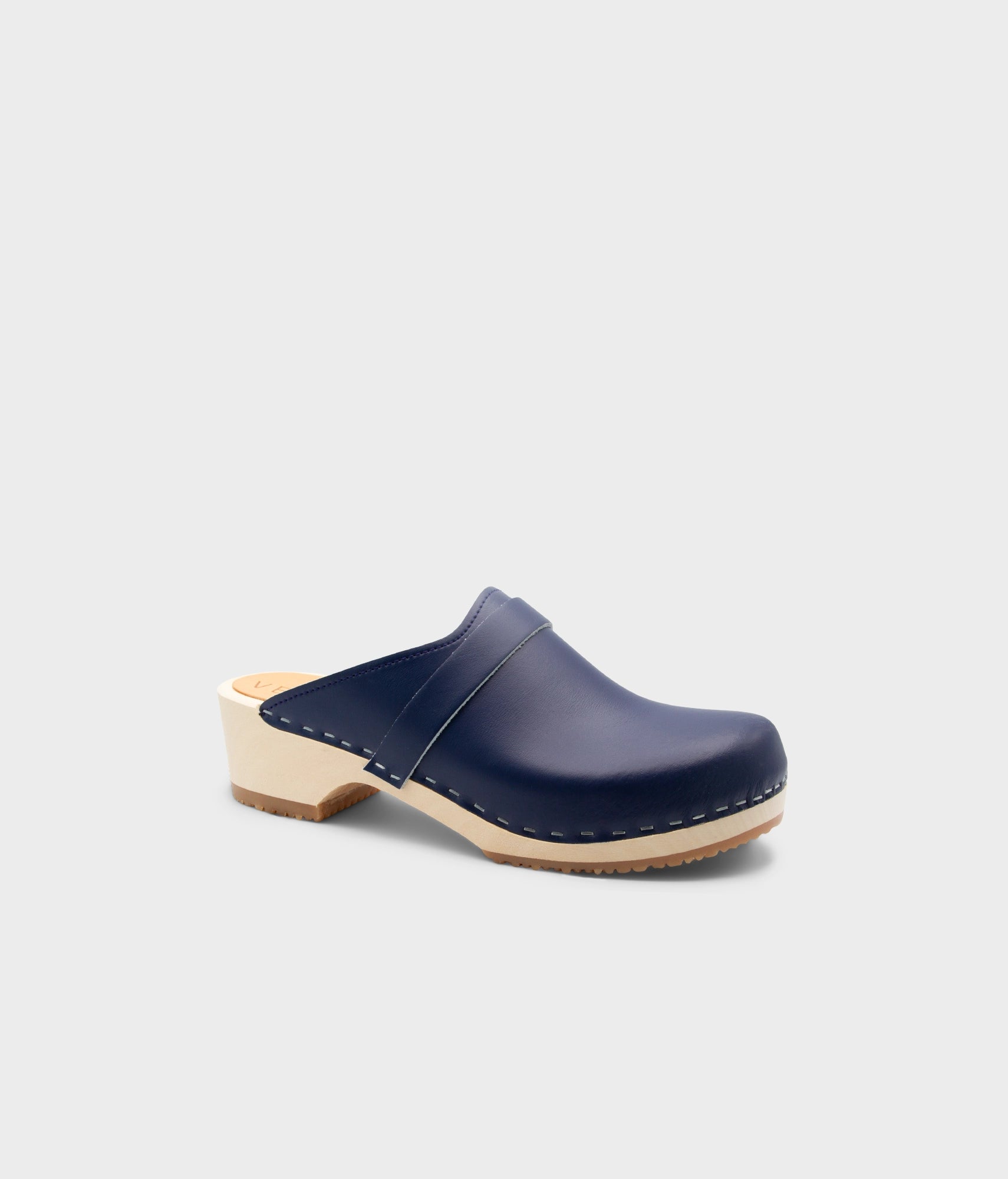 Navy blue clog shoe on a light gray background
