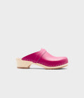 Pink clog shoe on a light gray background