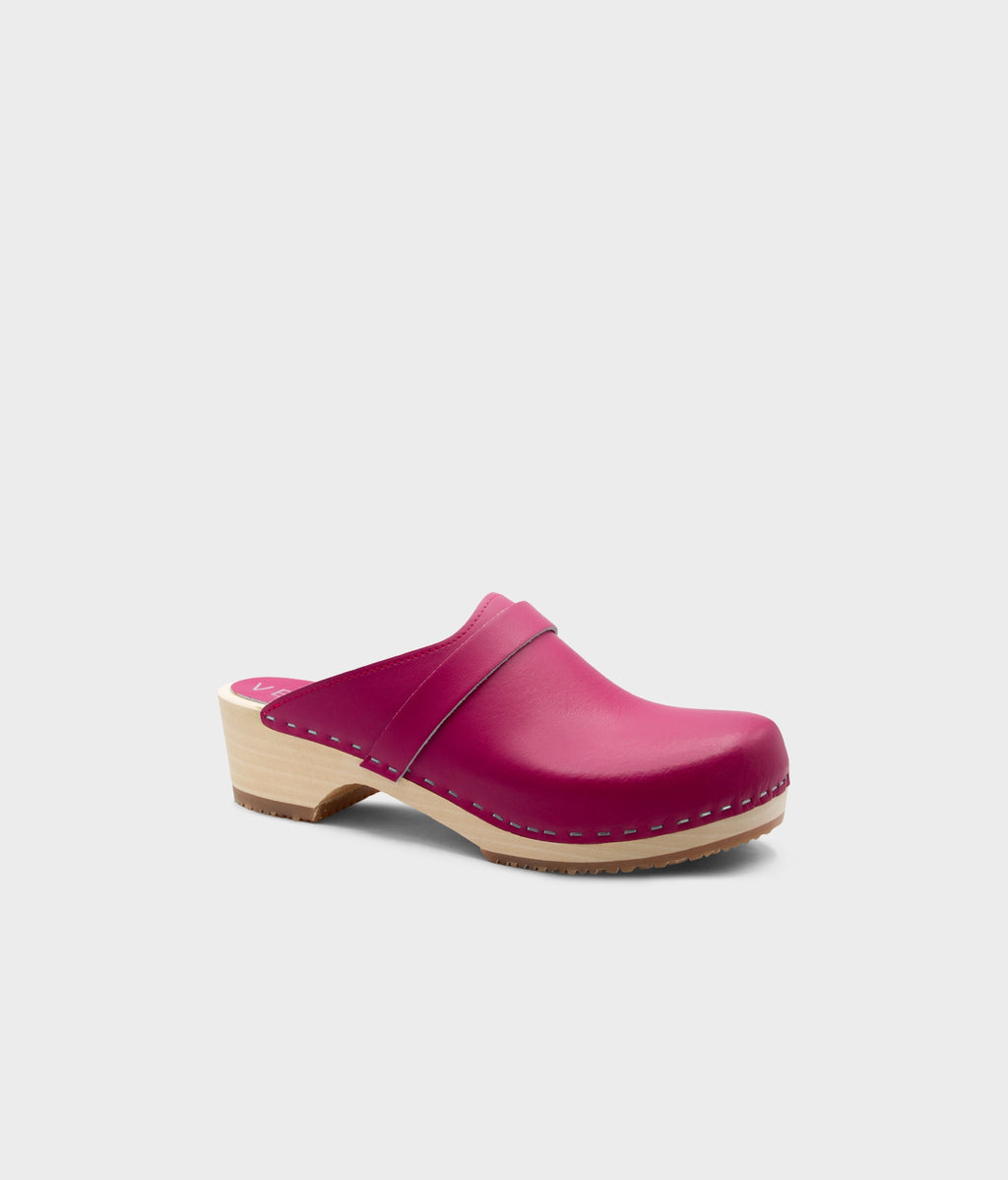 Pink clog shoe on a light gray background