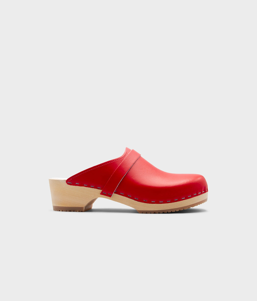 Red clog shoe on a light gray background