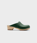 Green clog mule on a light gray background
