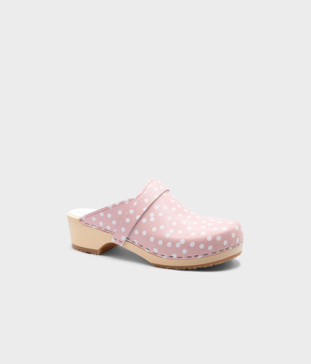 Pink polka dot clog mule on a light gray background