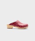 Red polka dot clog mule with wooden sole on a white background