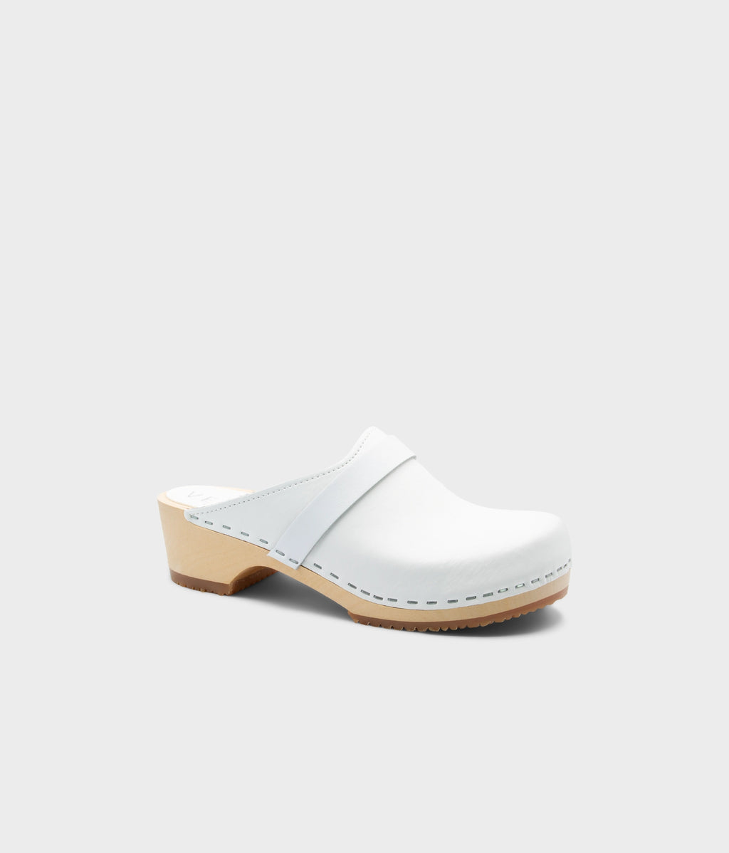 White wooden clog mule on a light gray background