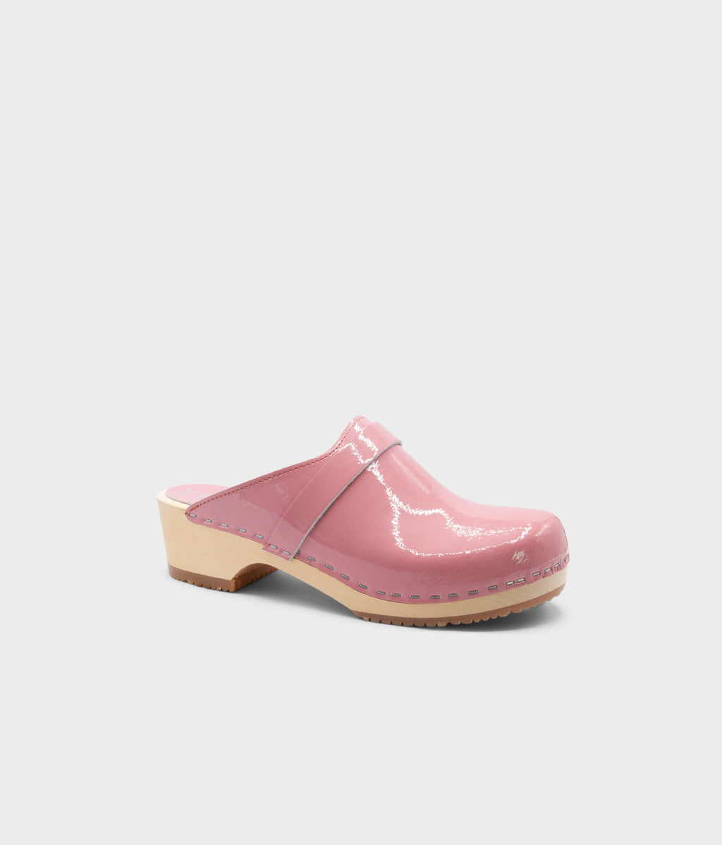 Pink clog shoe on a light gray background