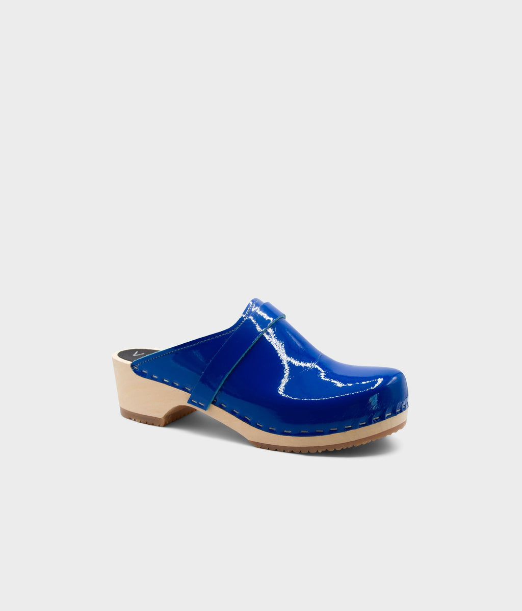 Blue clog mule on a light gray background