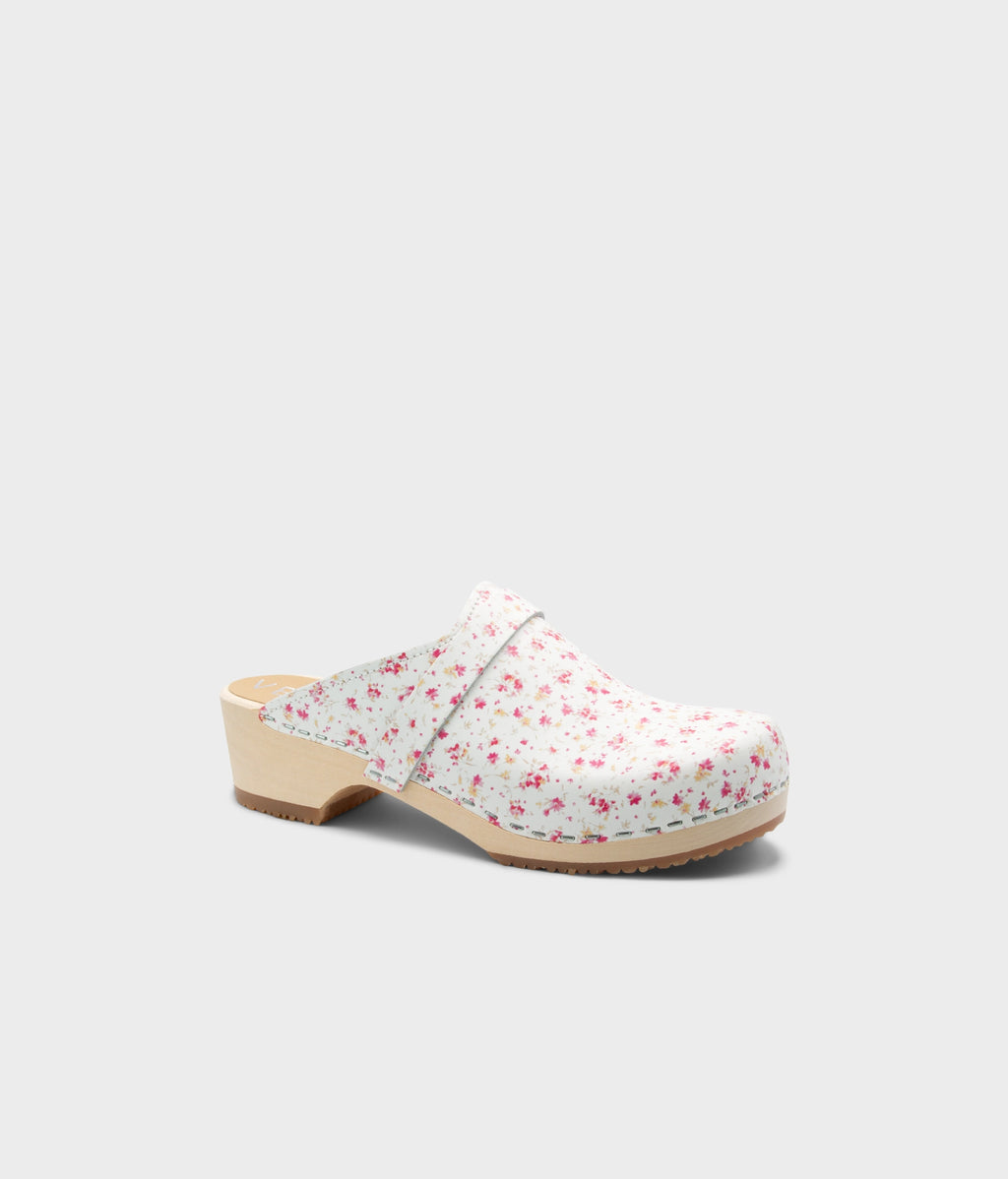 Floral-patterned clog shoe on a light gray background