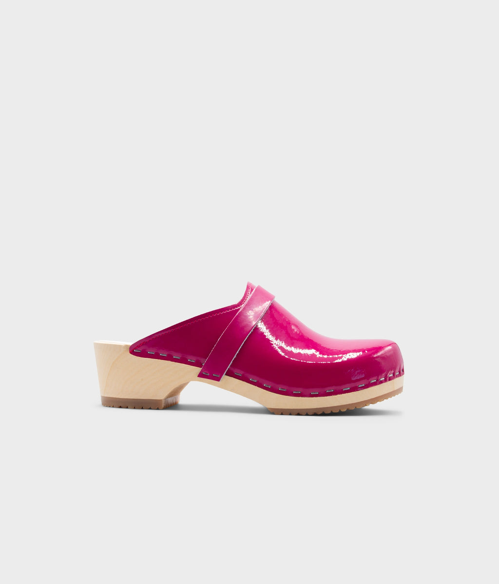 Pink clog shoe on a light gray background