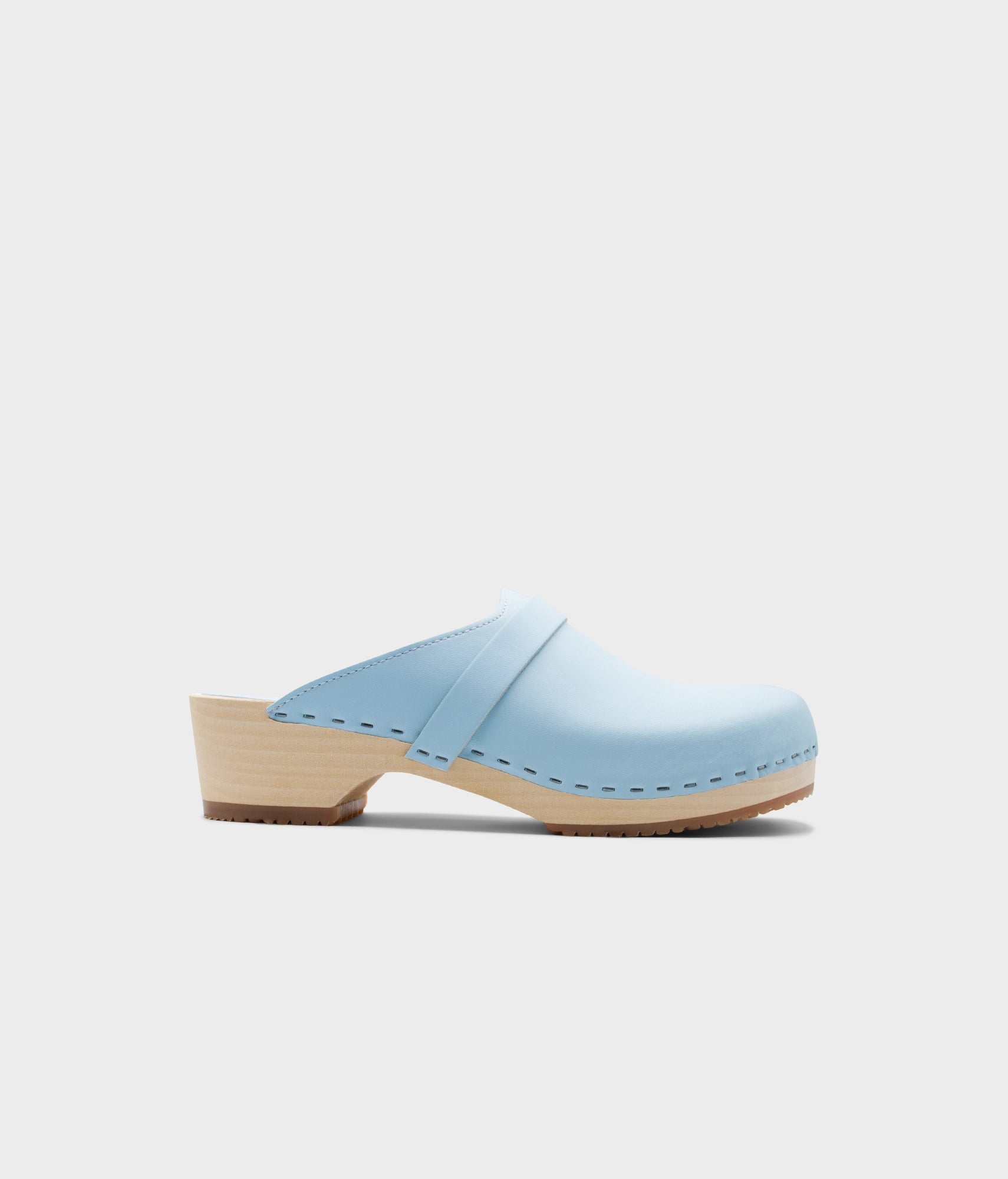 Light blue clog shoe on a white background