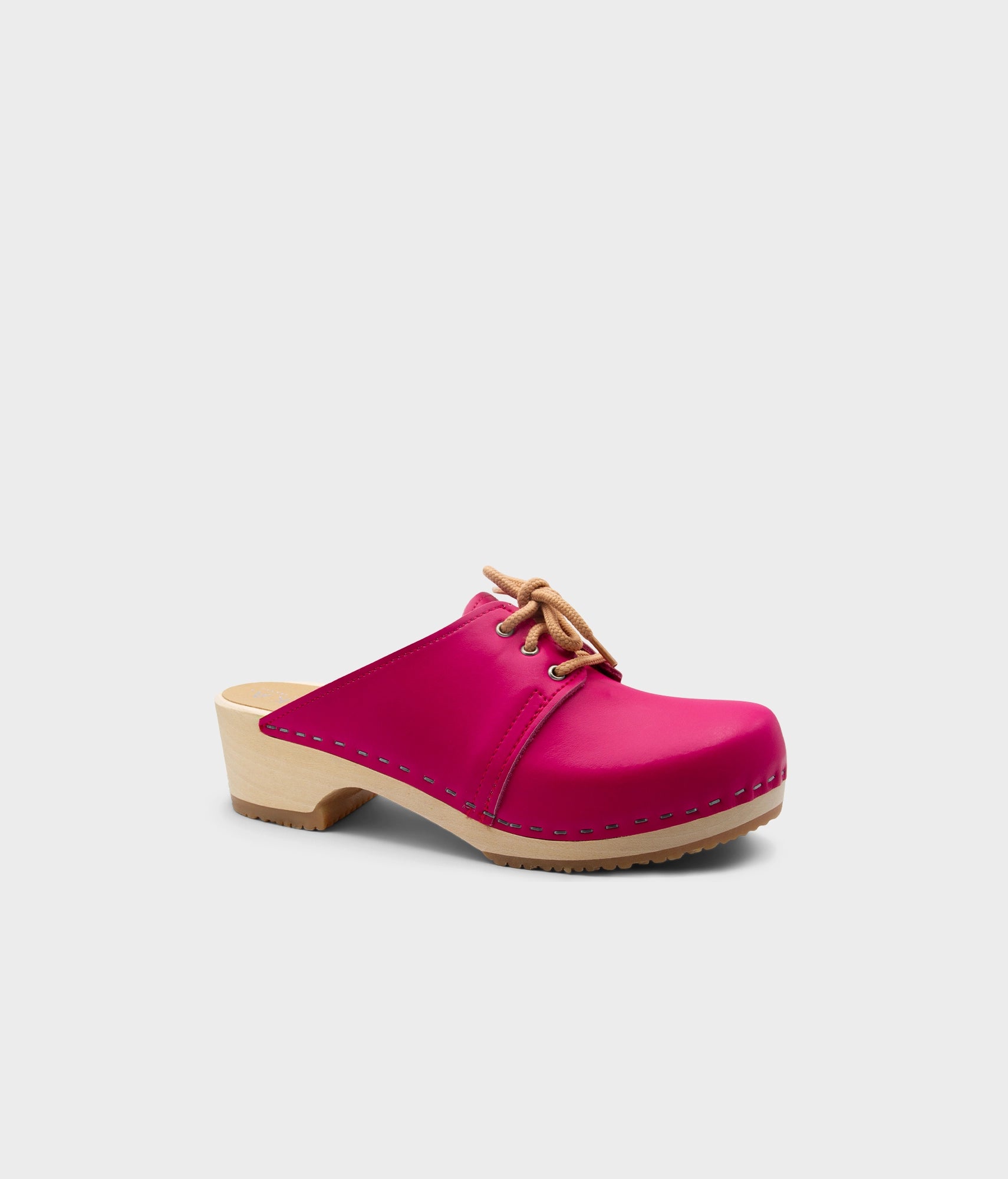Pink clog shoe with brown sole on a light gray background