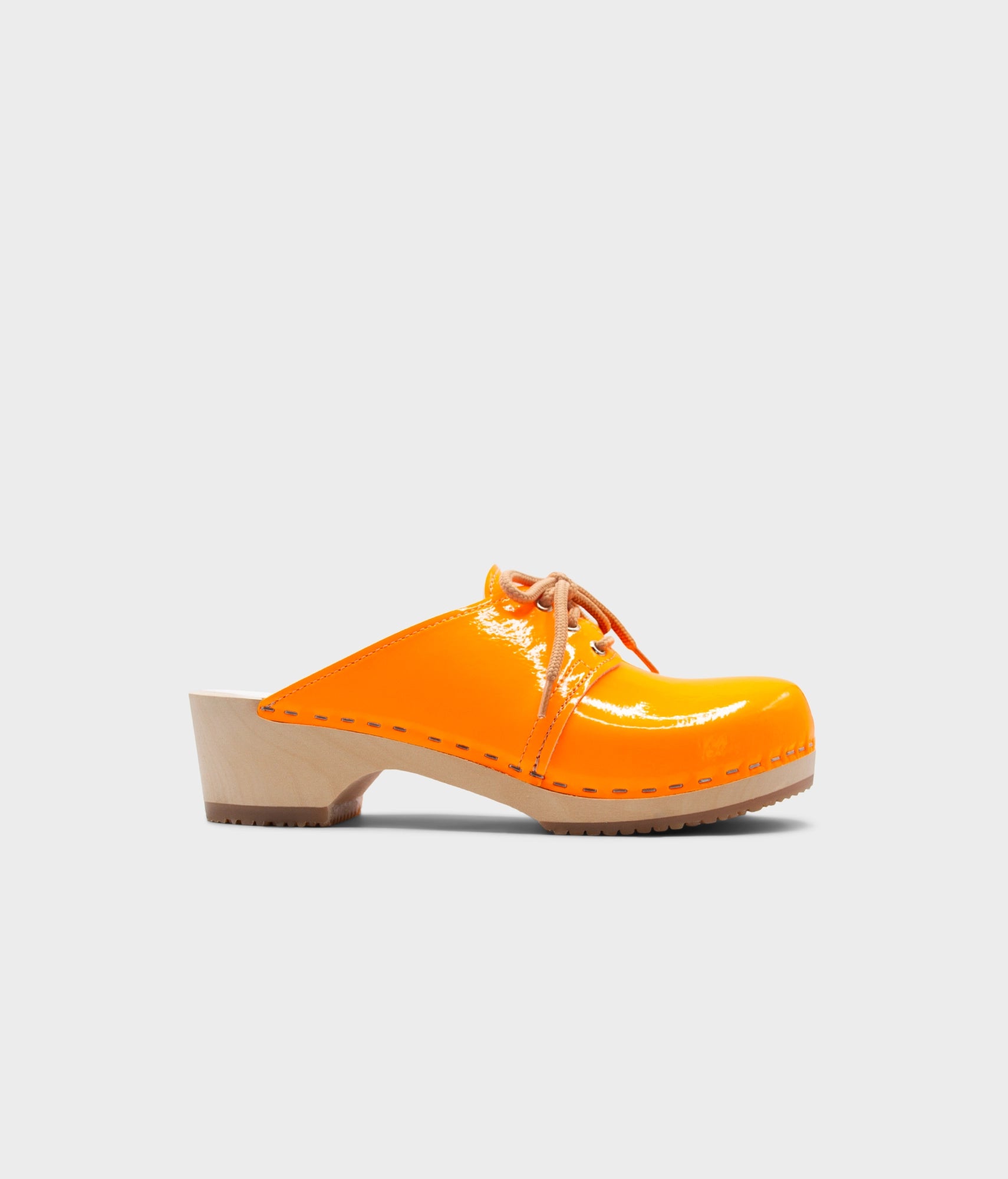Orange clog shoe on a light gray background