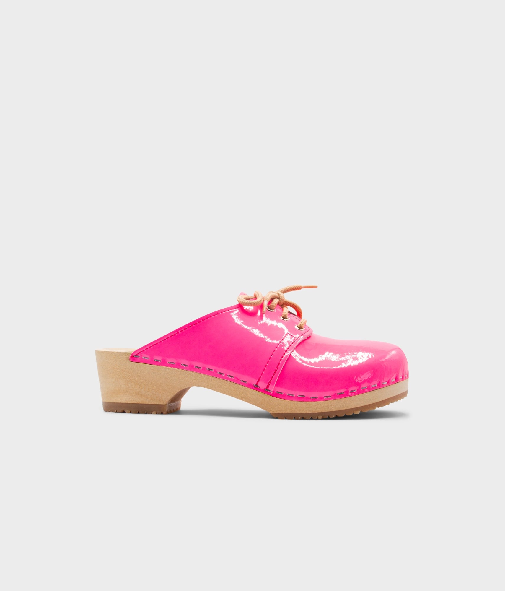 Pink clog shoe on a light gray background