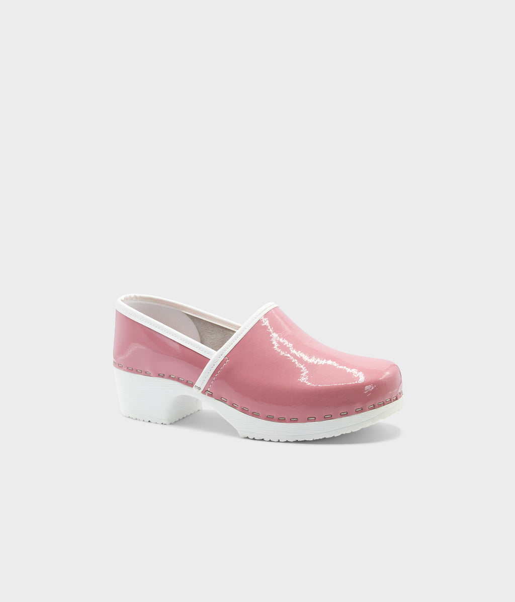 Pink clog shoe with white sole on a light gray background
