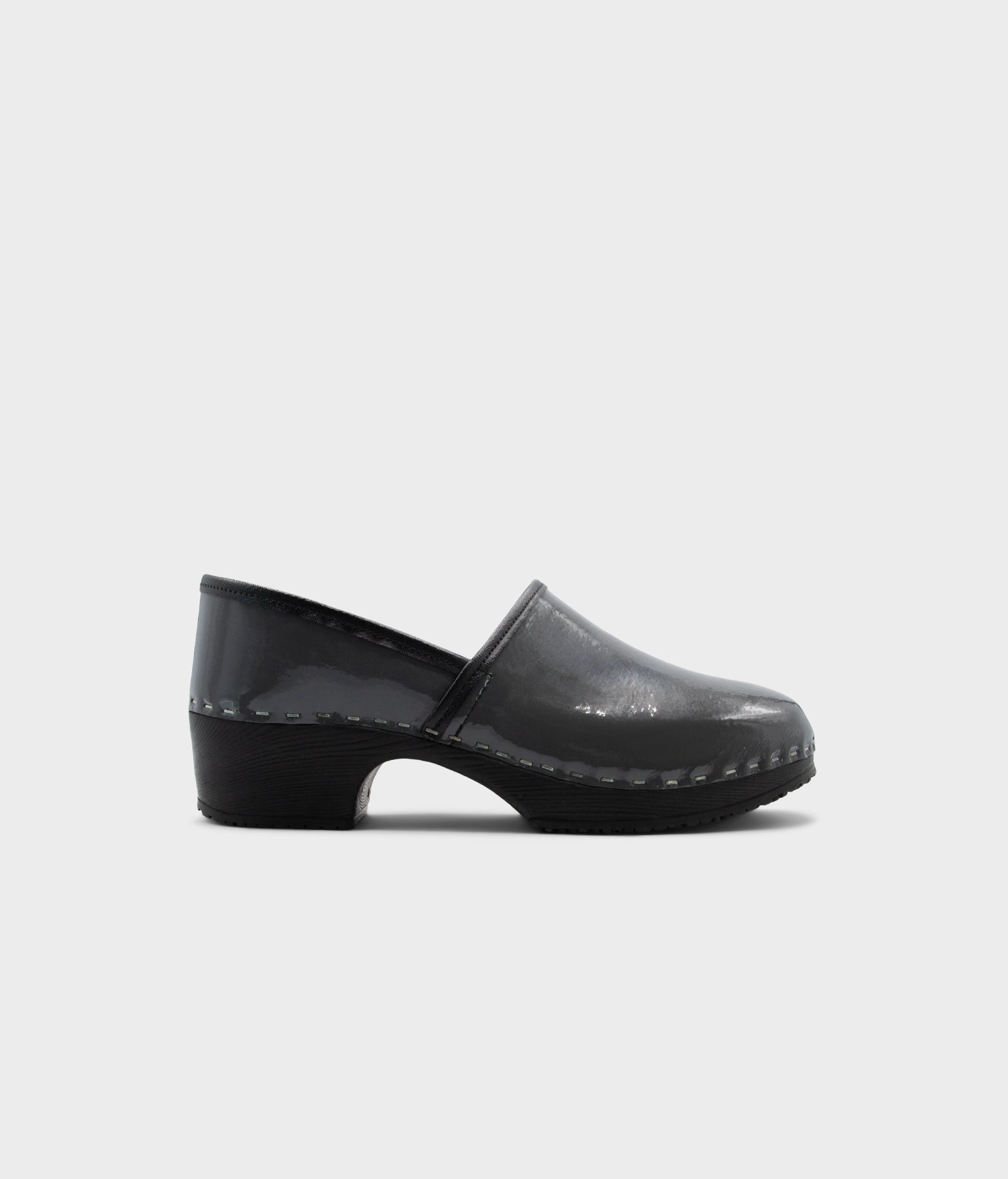 Black clog shoe on a light gray background
