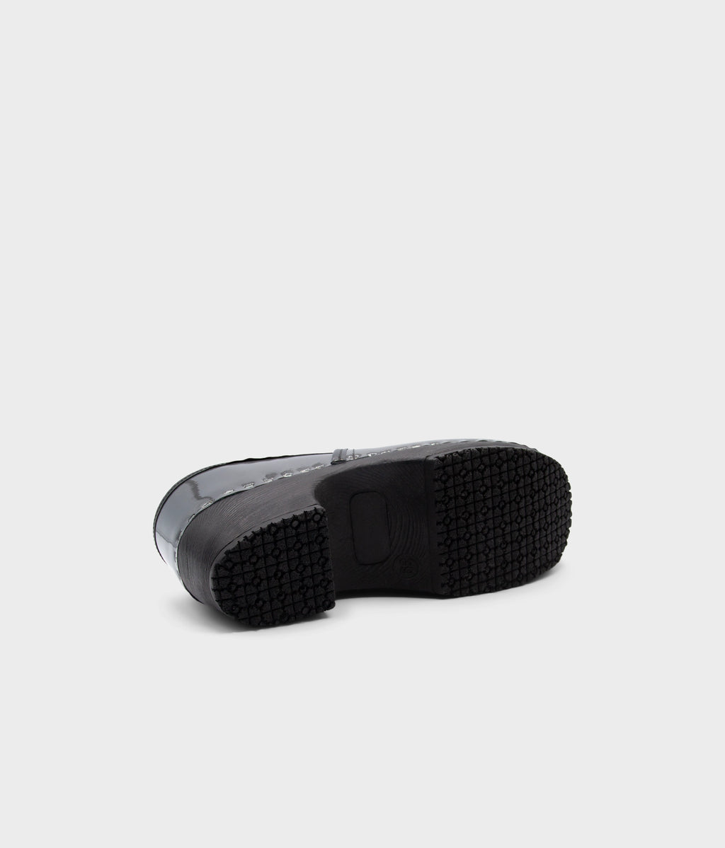 Black rubber sole of a shoe on a light gray background