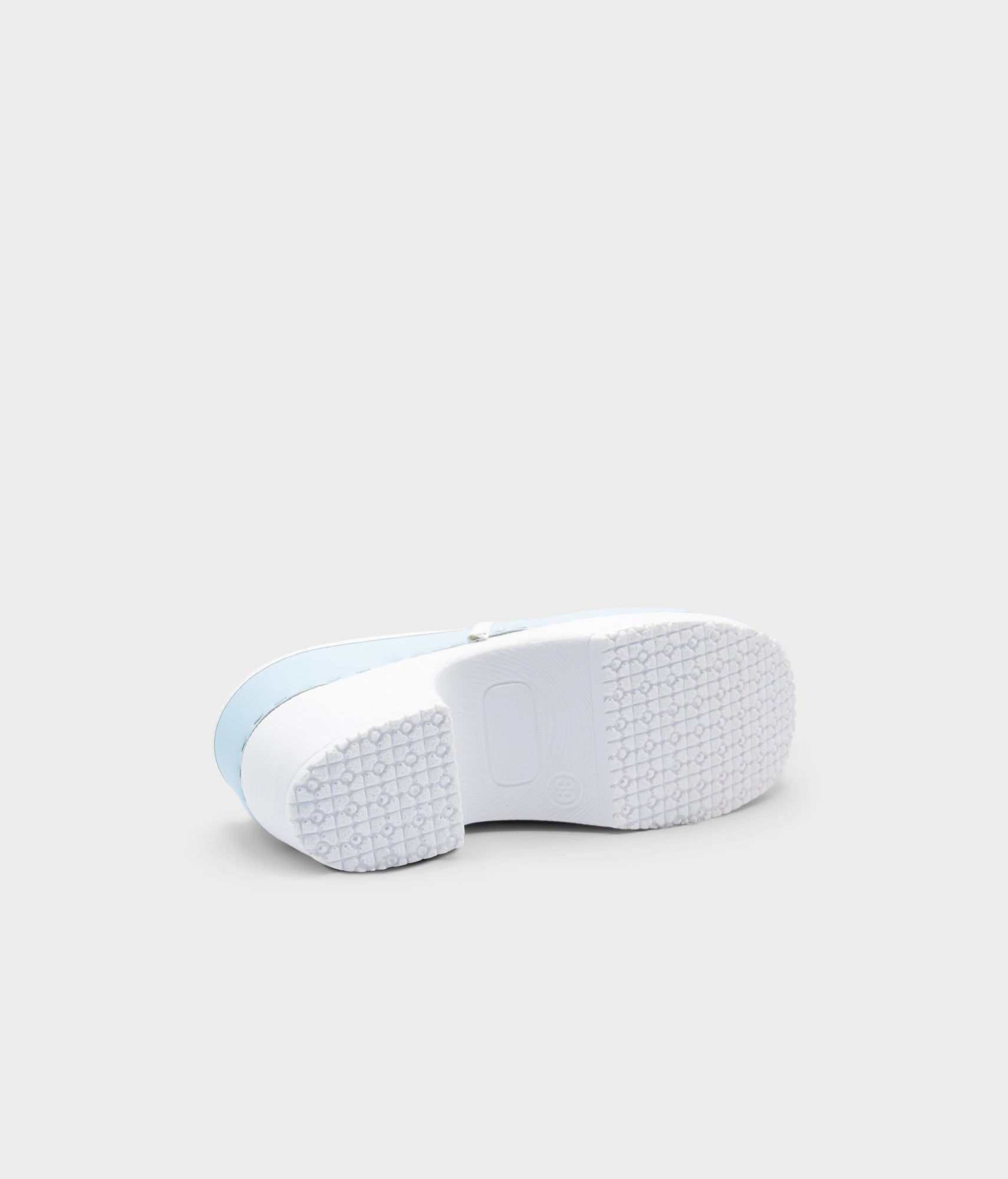 White sneaker with light blue sole on a white background