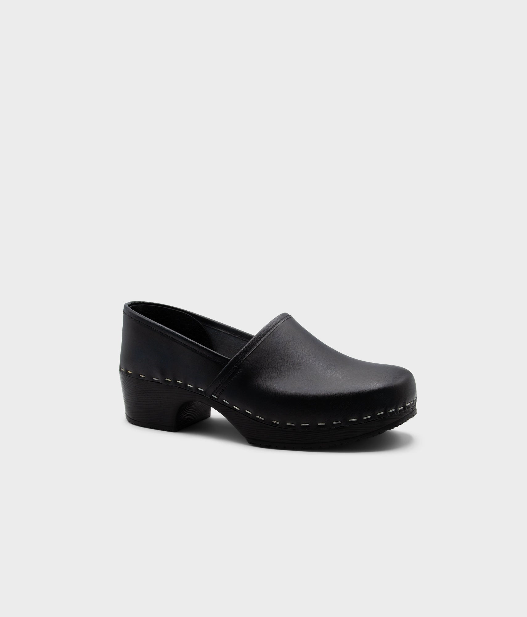 Black clog shoe on a light gray background
