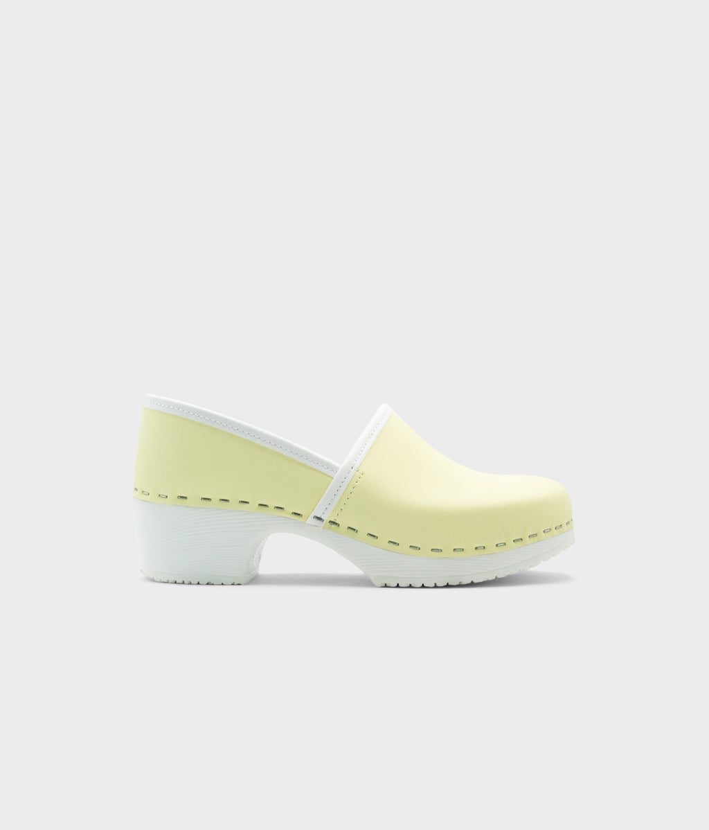 Light yellow clog shoe on a white background