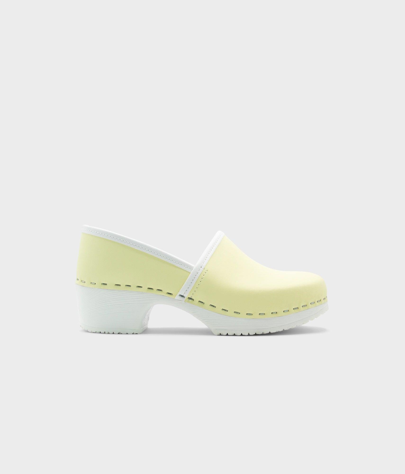 Light yellow clog shoe on a white background