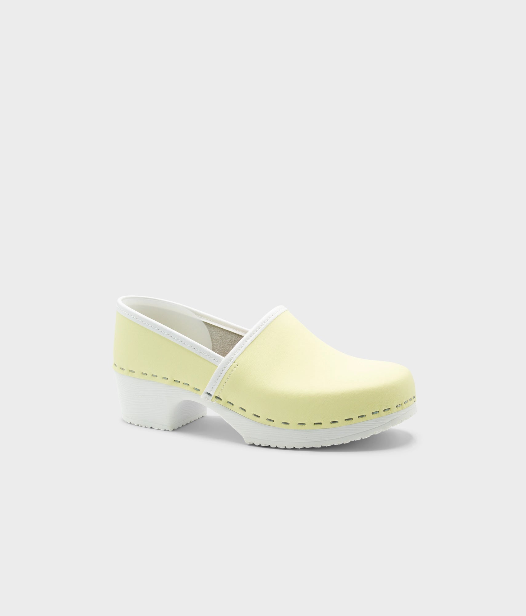 Light yellow clog shoe on a white background