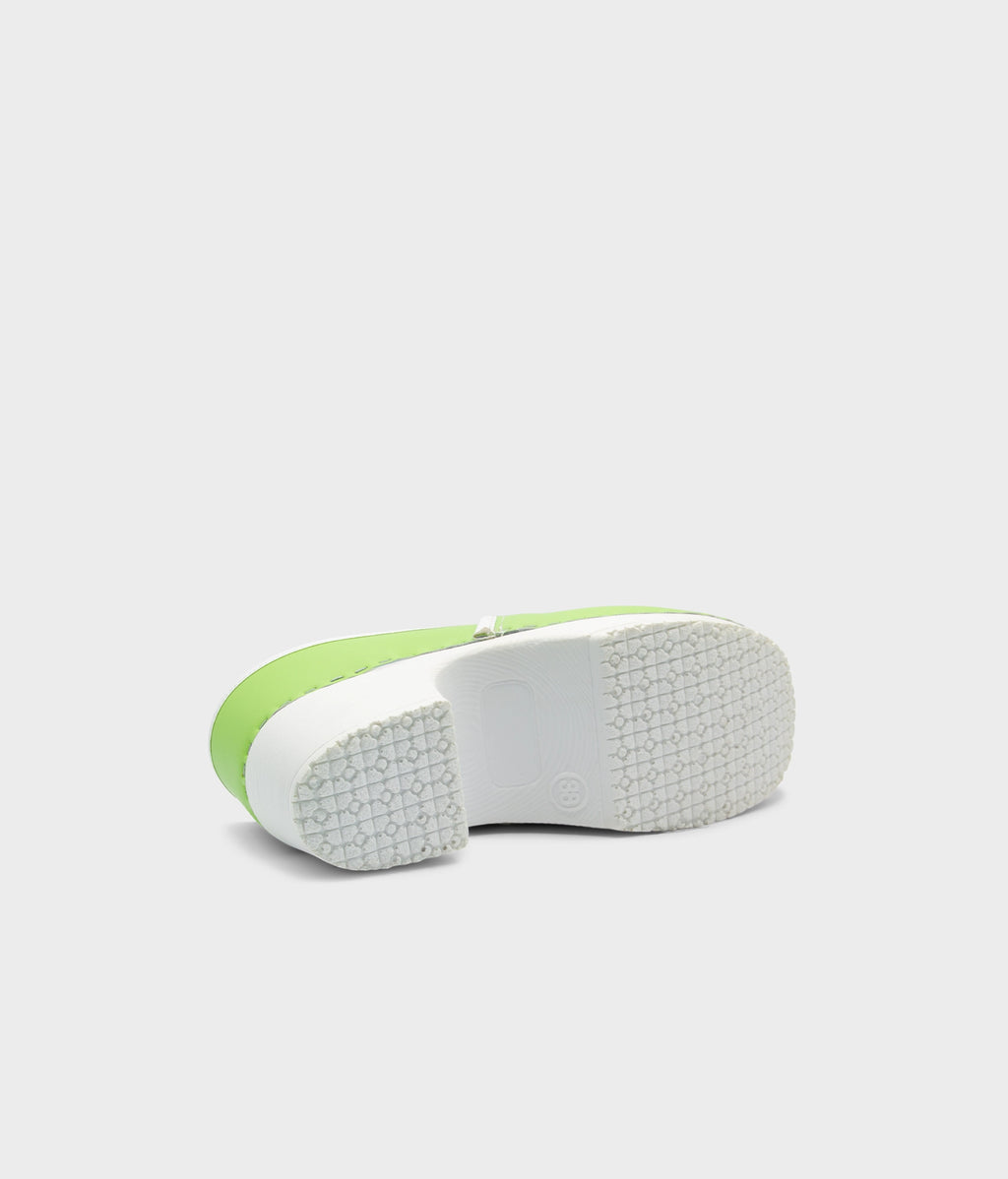 Close-up of a green and white shoe sole on a light gray background