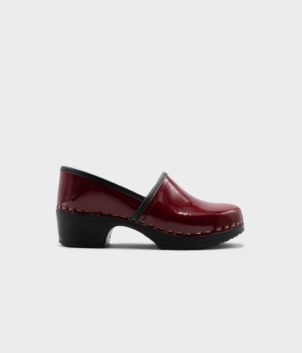 Single maroon clog shoe on a white background