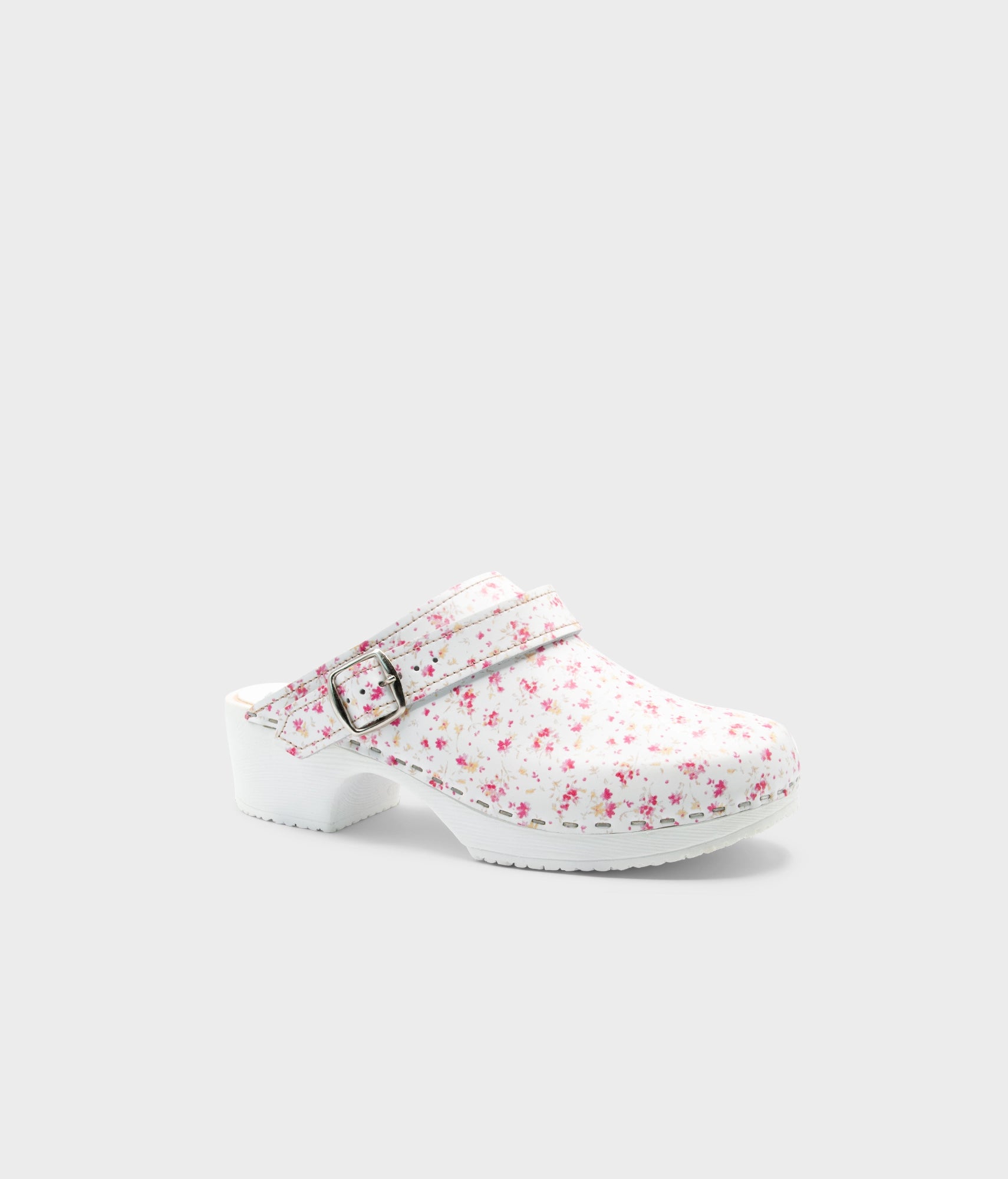 Floral-patterned clog shoe on a light gray background