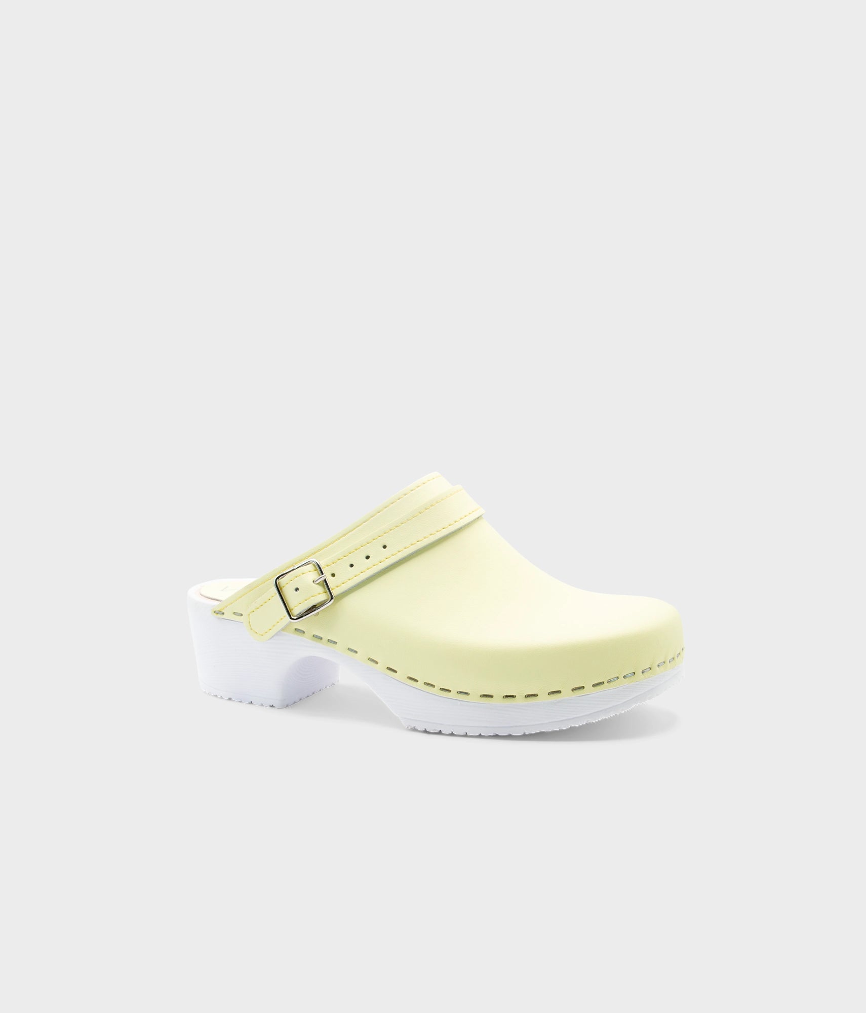Light yellow clog shoe on a white background