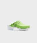 Green clog shoe with white sole on a light gray background
