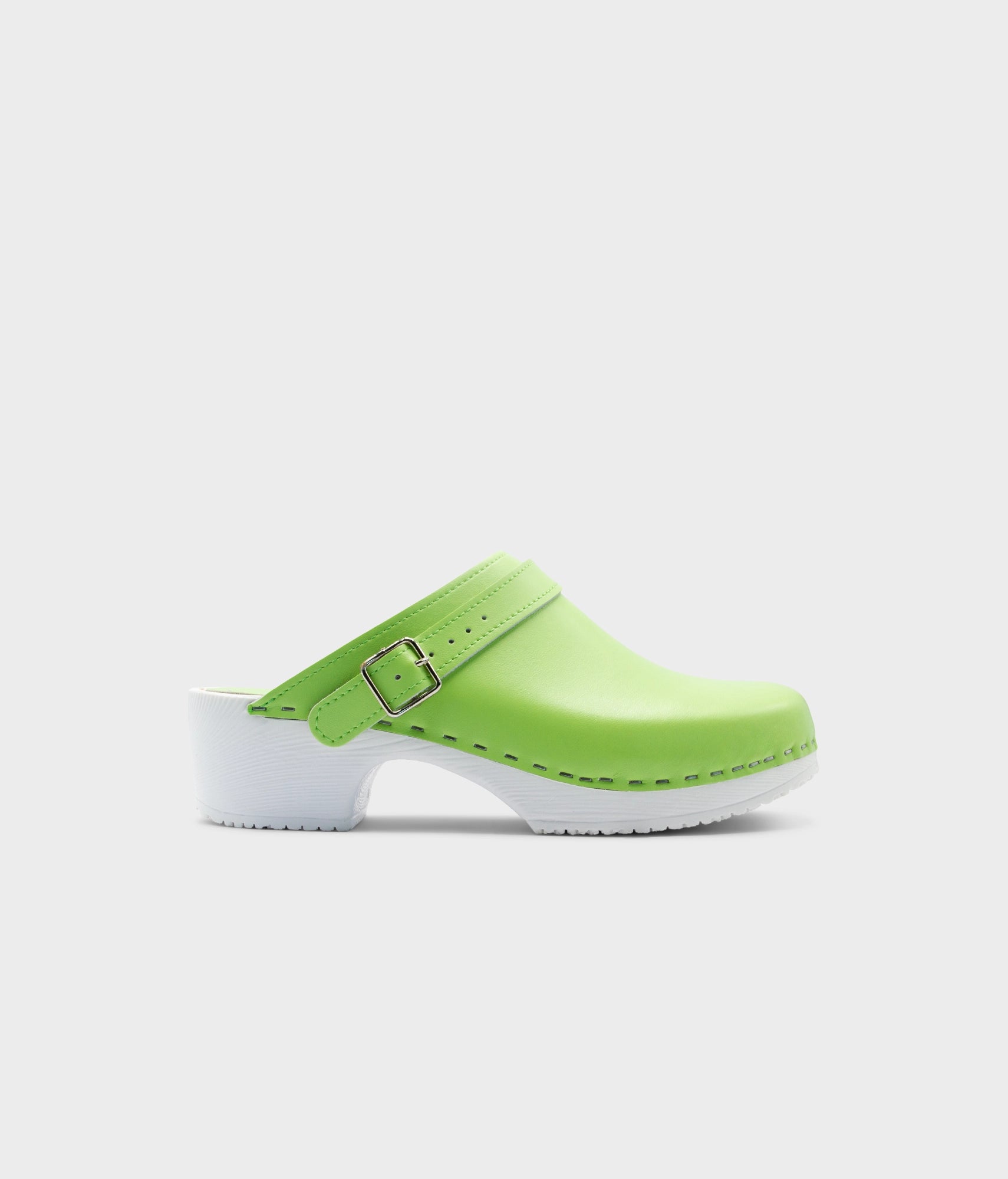 Green clog shoe with white sole on a light gray background