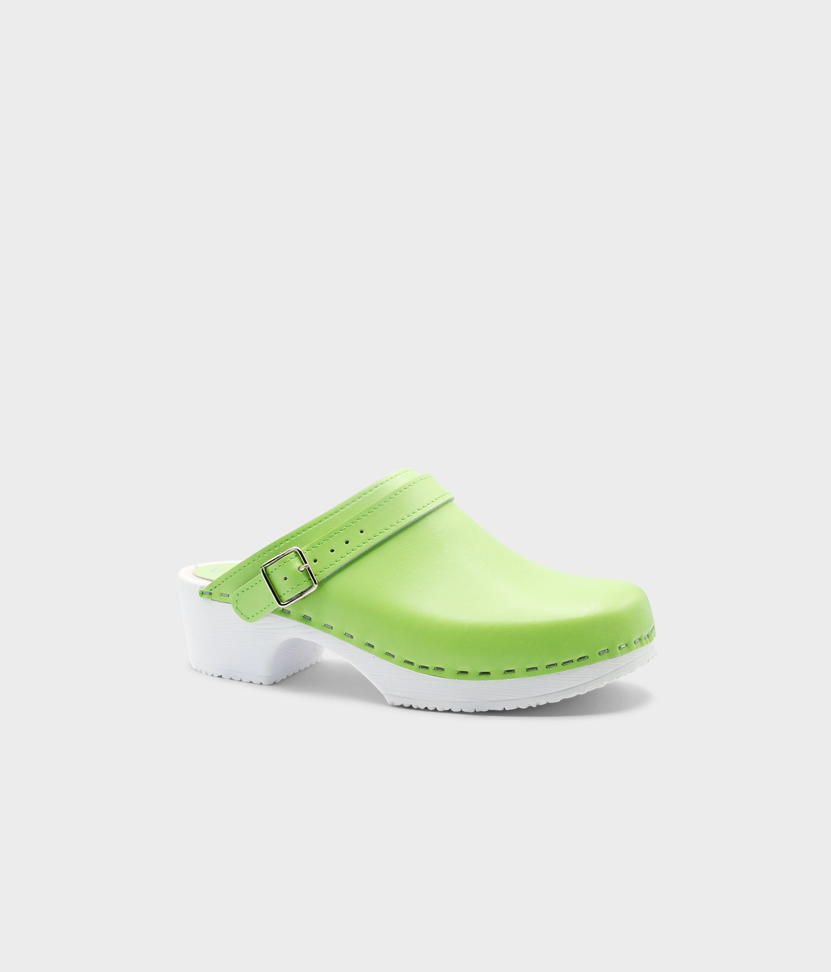 Green clog shoe with a white sole on a light gray background