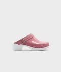 Pink clog shoe with a white sole on a light gray background