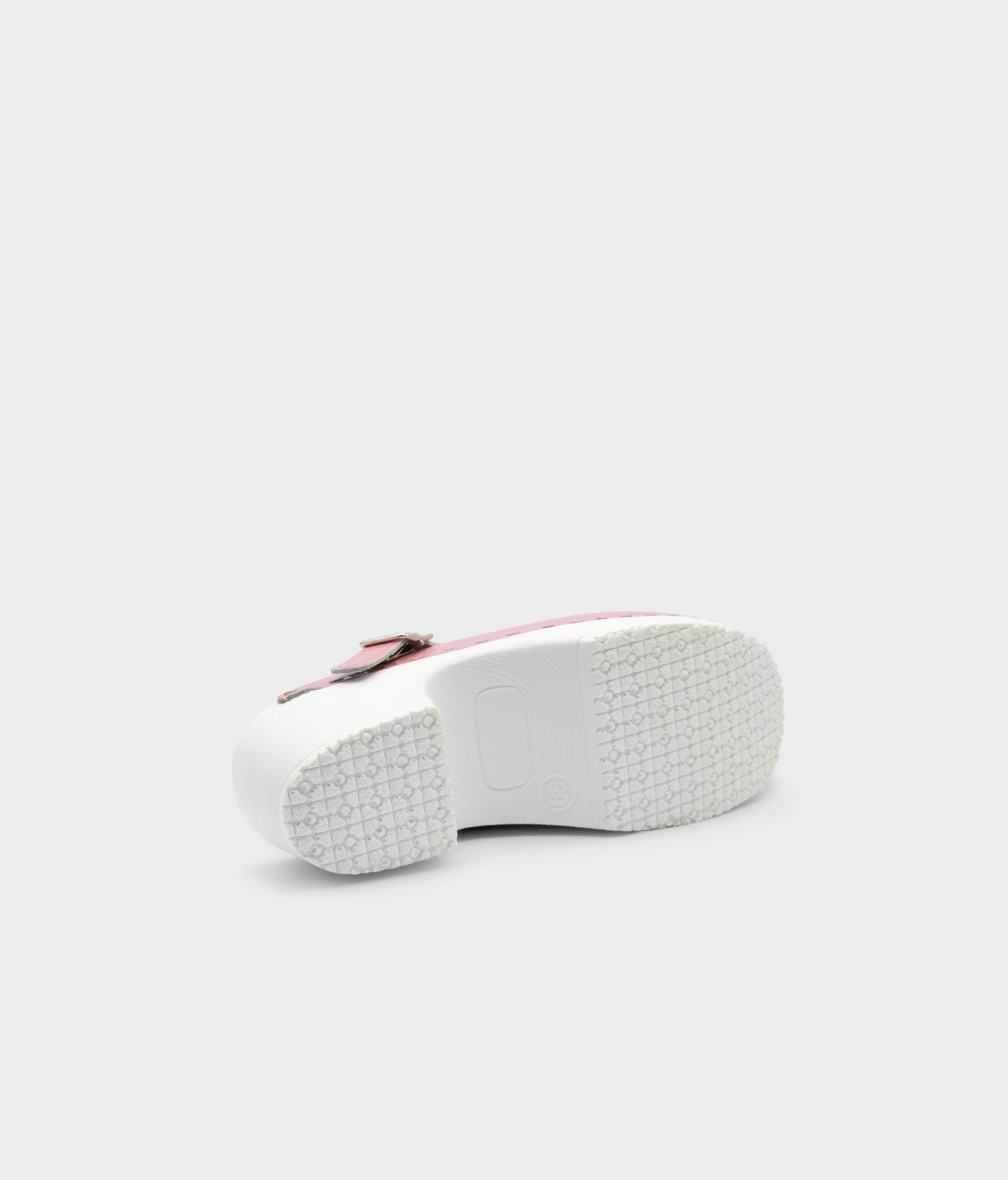White sneaker with a red sole on a light gray background