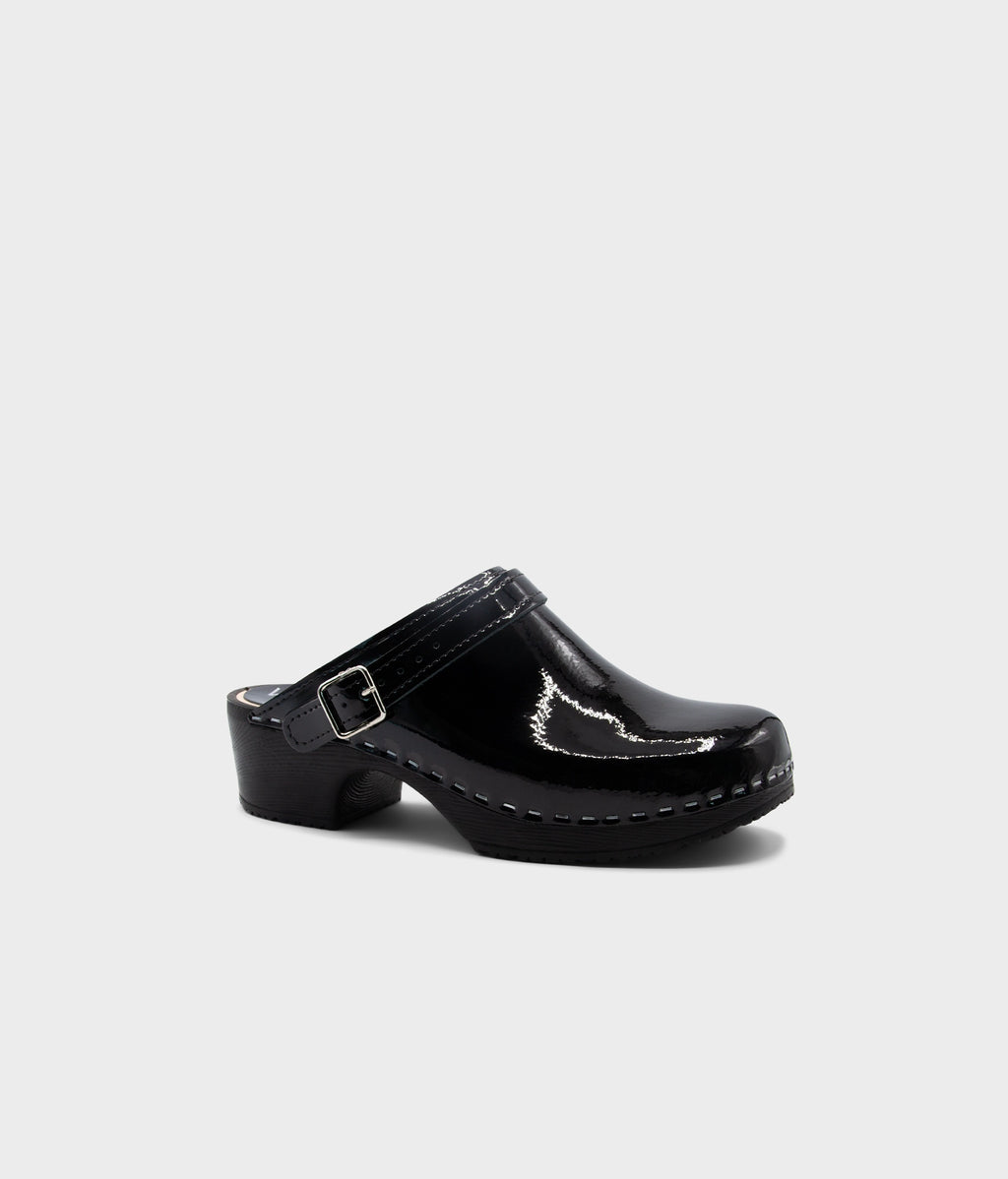 Black clog shoe on a light gray background